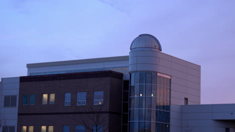 building with astronomical observatory at dusk.