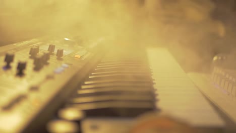 Old-fashiones-midi-piano-keybord-covered-in-smoke