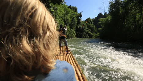 lady sitting on a bamboo raft