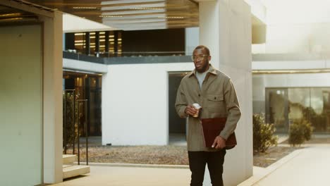 businessman walking and drinking coffee