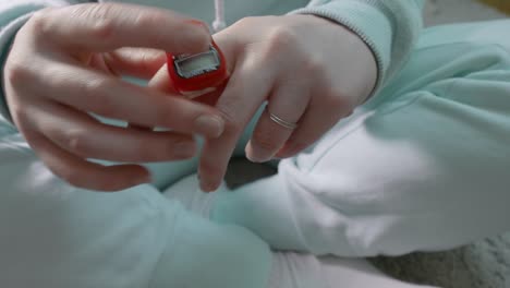 woman's hands putting on tally counter on finger. woman demostrates new unusual ring. close up view.