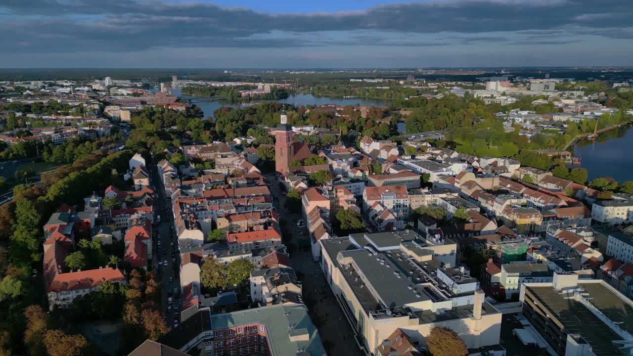 Berlin Spandau old town with its red rooftops, churches, and surrounding greenery. Unique aerial view flight fly reverse drone