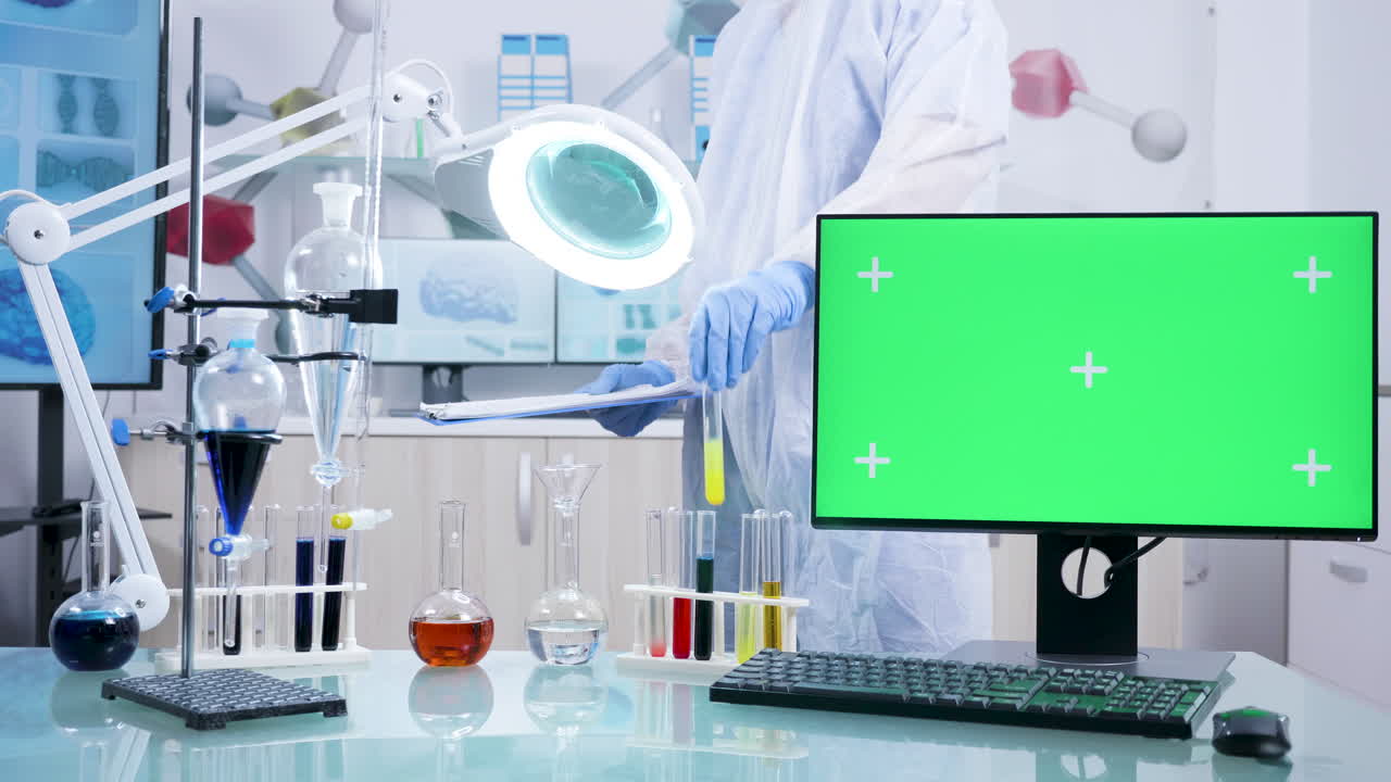 Scientist in Lab with Green Screen Monitor