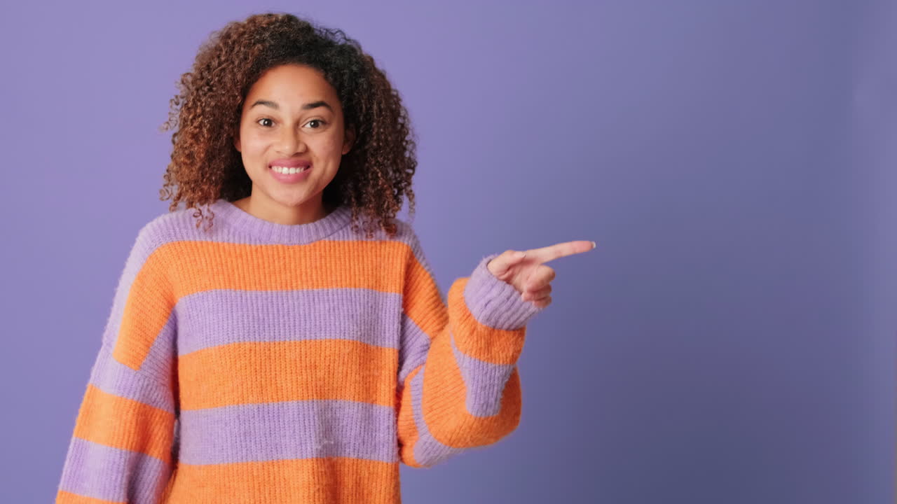 Young Woman Reacts with Surprise and Points to Copy Space