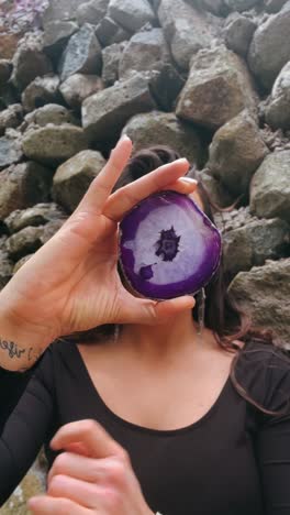 purple agate crystal held in hand