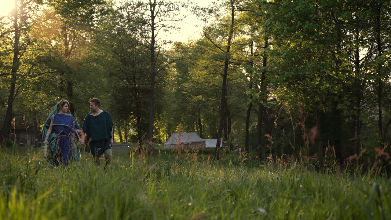 Couple Walking Through a Forest at Sunset