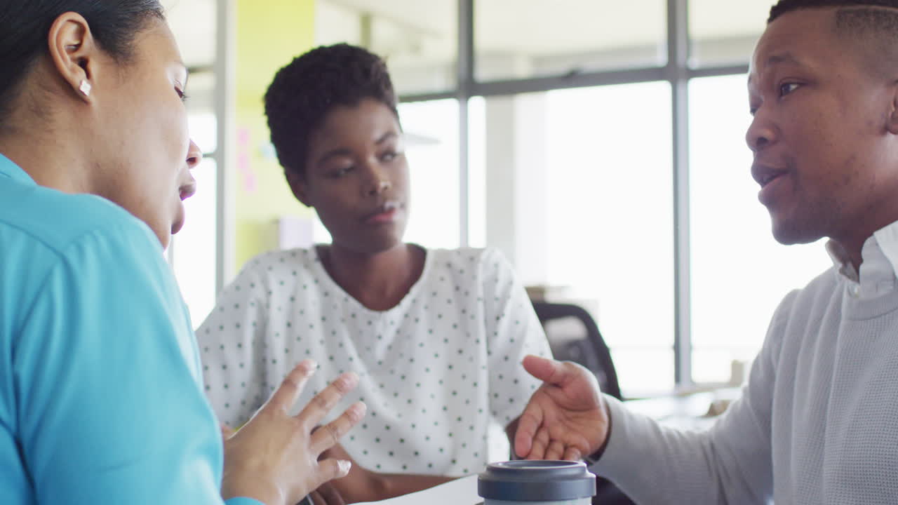 African american business people having meeting at office, slow motion