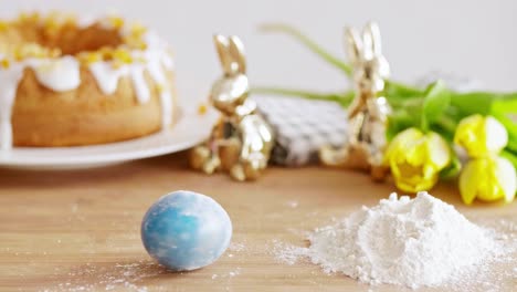 easter egg and flour on the wooden table