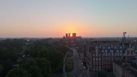 high pullback establishing aerial drone shot of york city walls and minster at sunrise uk