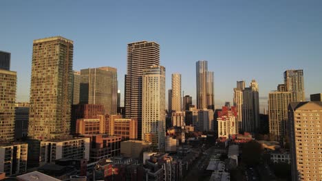 aerial trucking shot of urban skyline in famous banking district named canary wharf during sunset