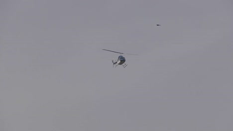 helicopter flies over on cloudy day