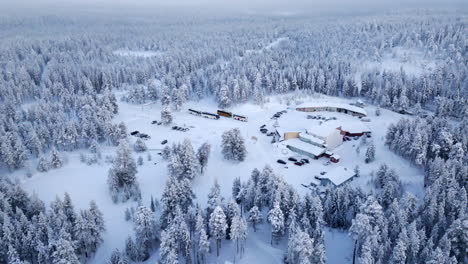 aerial view of a snowy forest lodge in finland