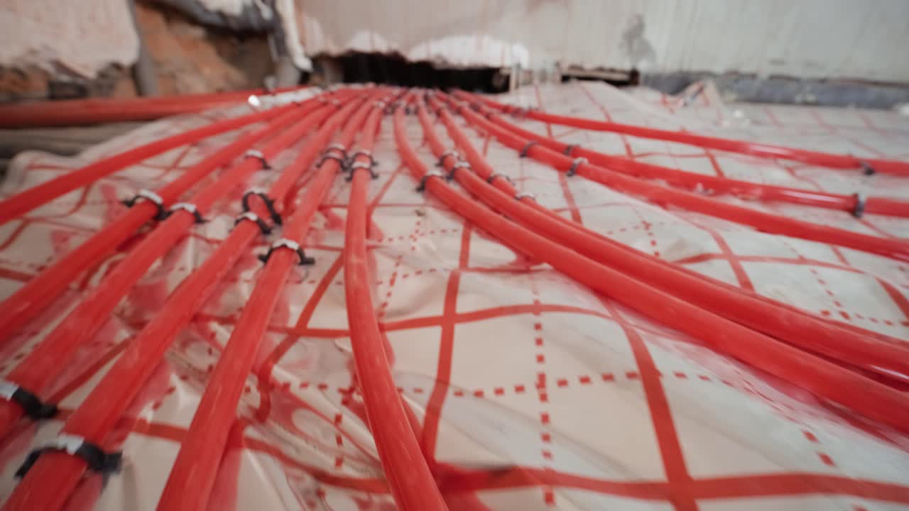 Installing underfloor heating pipes for water heating. Heating systems. Pipes for a heat-insulated floor.