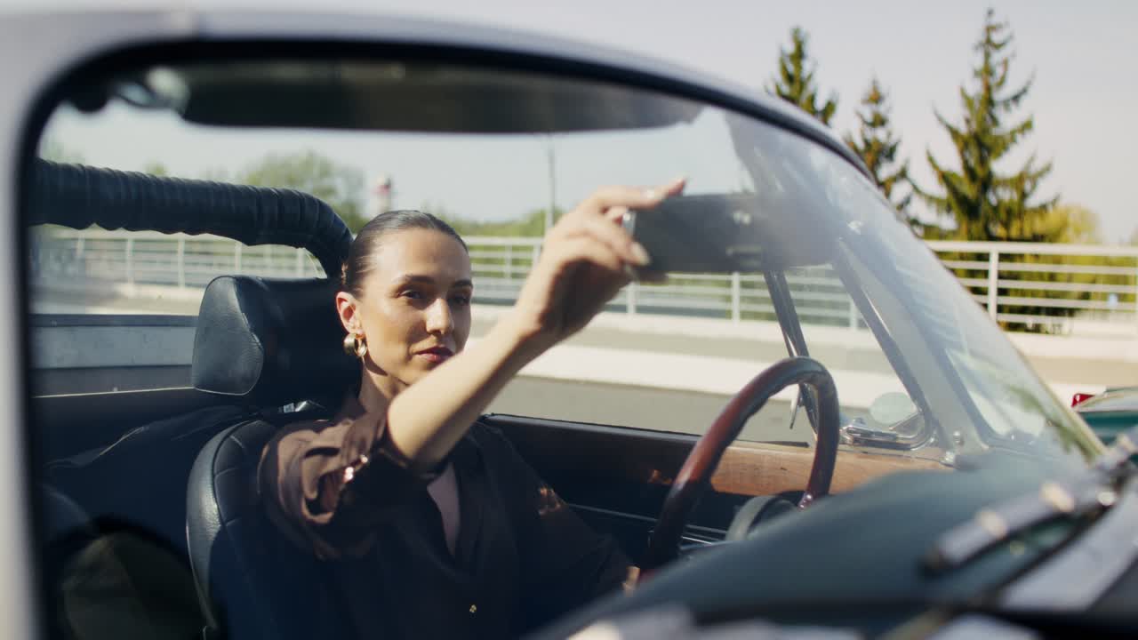 Woman Driving a Vintage Convertible Car
