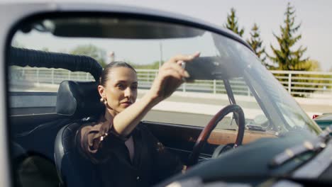 woman driving a vintage convertible car