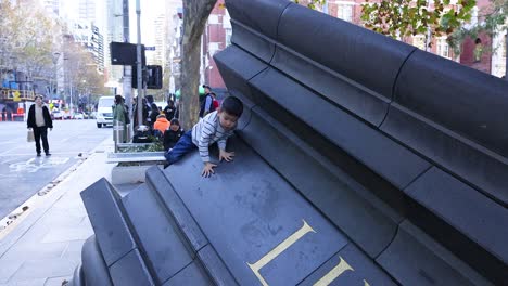 children climbing and playing on city sculpture