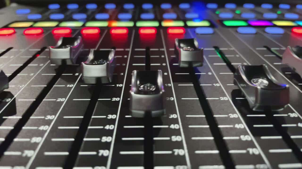 Slider view of audio mixing desk or console, moving volume faders, digital automated motion
