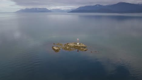 vanderbilt reef aerial view, surrounded by ocean with mountains in the background