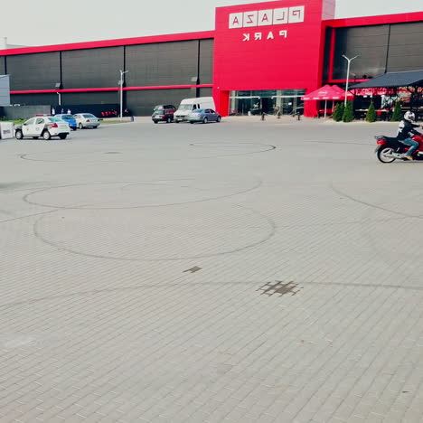 two professional motobikers racing highspeed on a road in a circle way. bikers on their motorcycles training riding on the background of city with modern buildings.