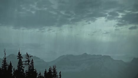 heavy rain moves trough the mountains with lightning