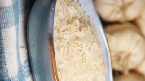 uncooked rice in a bowl with garlic