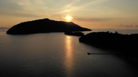 sunset over tropical islands with a pier