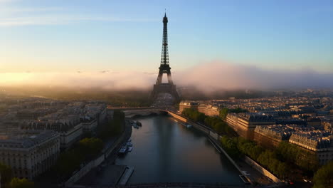 eiffel tower and seine river at sunrise in foggy paris