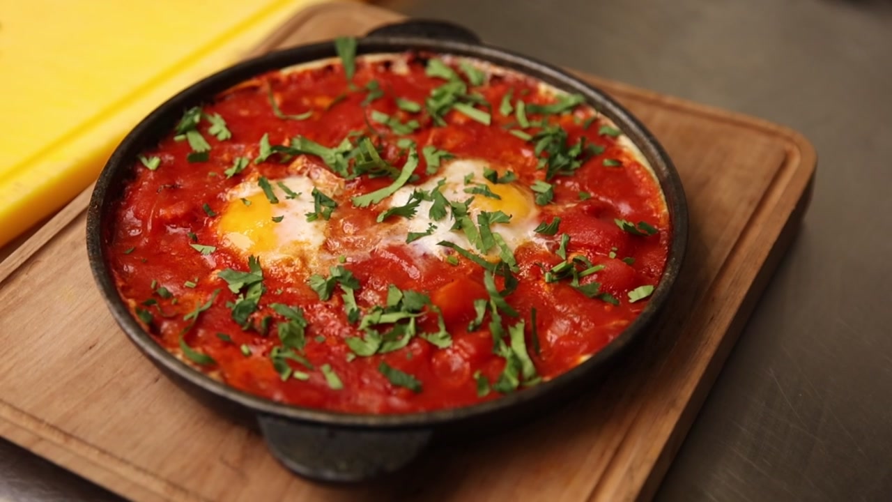 Appetizing Shakshuka with Eggs and Tomato Sauce in a Skillet