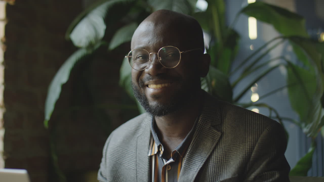 Portrait of Cheerful Black Businessman in Cafe