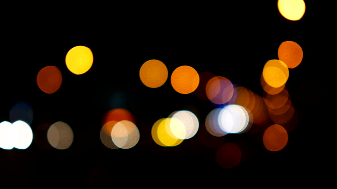 luces desenfocadas calle de los ángeles resumen. fondo borroso de la ciudad. círculos de bokeh en movimiento del tráfico nocturno.