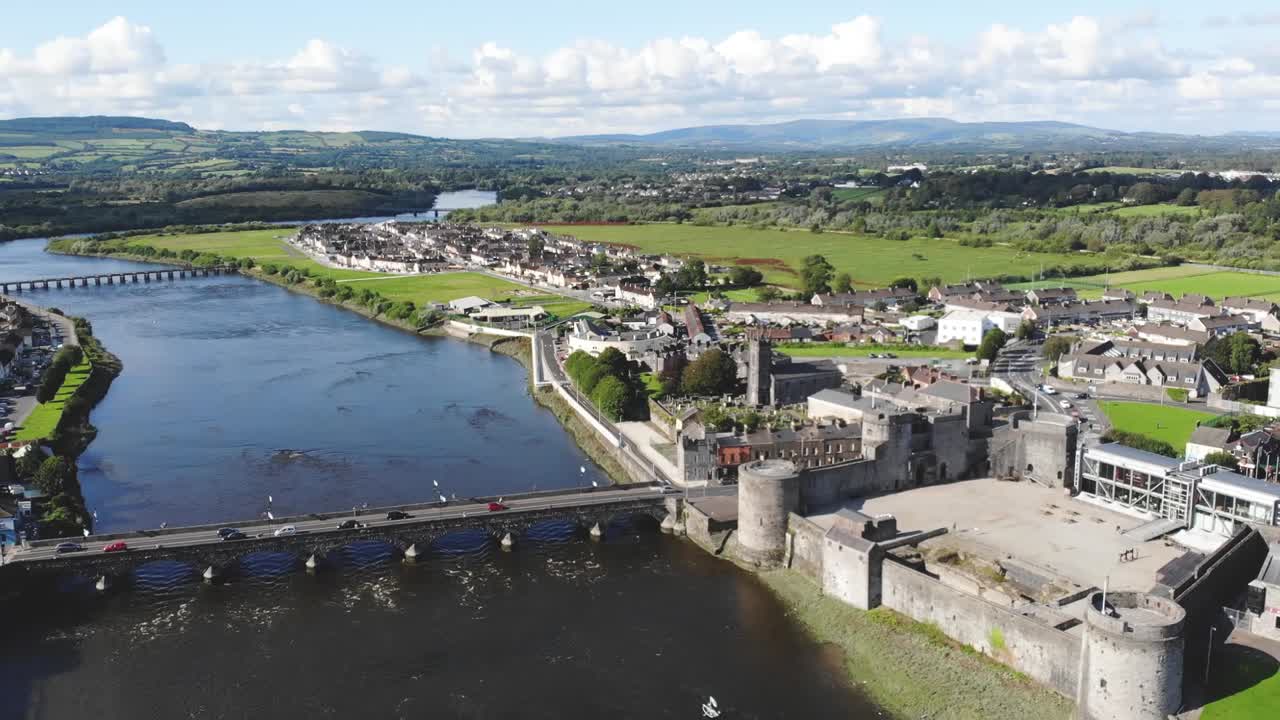 Summer over Shannon river in Limerick, Ireland. Drone reveal of King John's Castle