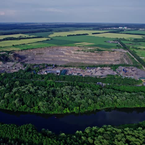 opencast granite mining quarry with working machinery