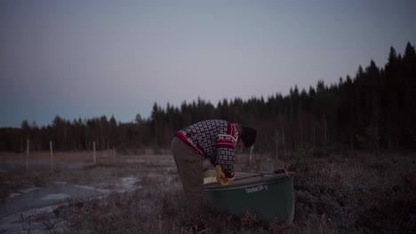 a man is inspecting his boat - static shot