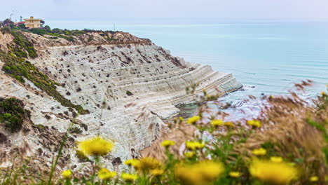 High-angle-shot-taken-of-Stair-of-the-Turks-which-is-a-rocky-cliff-on-the-southern-coast-of-Sicily,-Italy,-Europe-in-the-evening-in-timelapse