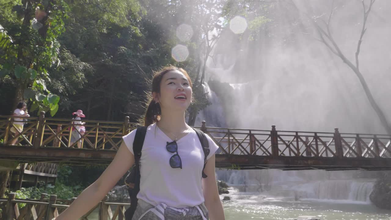 Woman enjoying a waterfall view