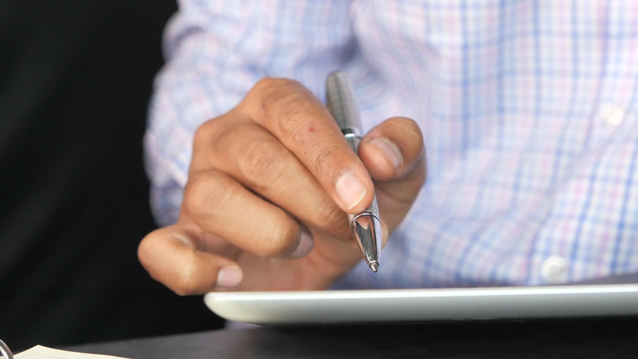 Person using a pen on a tablet