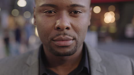 close up portrait of african american businessman looking up at camera smiling enjoying successful urban lifestyle achievement