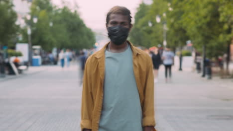 man wearing mask on city street