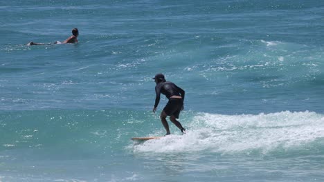 sequence of a surfer catching and riding a wave