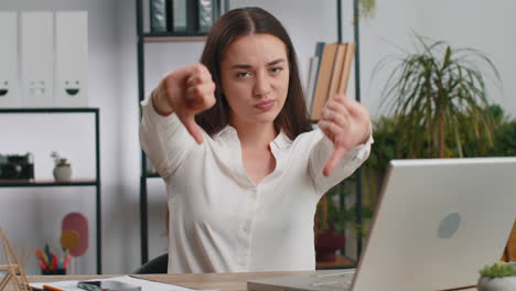 Upset-businesswoman-showing-thumbs-down-dislike-bad-work-disapproval-dissatisfied-feedback-at-office