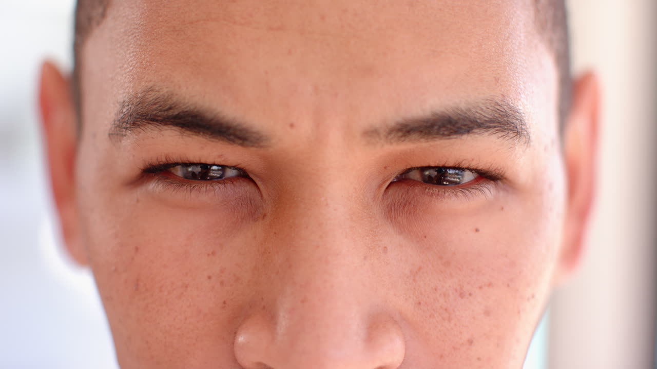 Pregnant couple holding ultrasound photo, smiling and celebrating upcoming baby