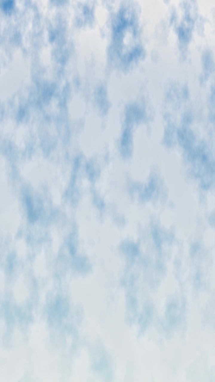 Soft White Clouds Drifting Across a Clear Blue Sky
