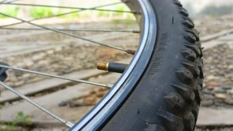 close up of opening the lid of a bicycle tire valve