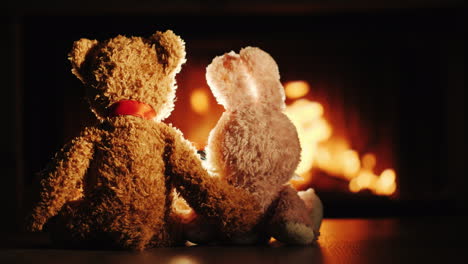 bear and rabbit in a hug sit by the fireplace valentine's day concept