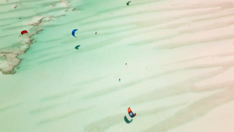 Kite surfers glide over shallow Zanzibar waters