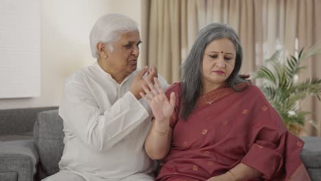 guilty old indian husband apologizing to his wife