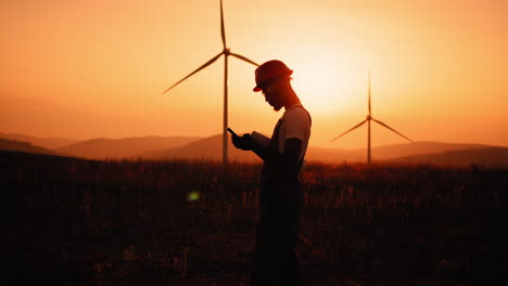 wind turbine engineer at sunset