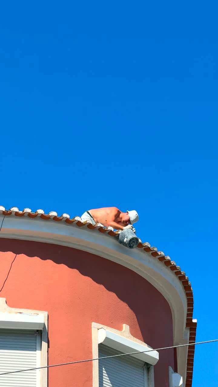 Roof repair work on a building with a curved roof