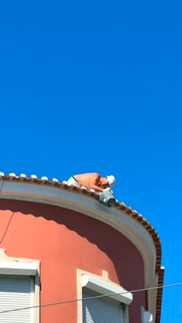 roof repair work on a building with a curved roof