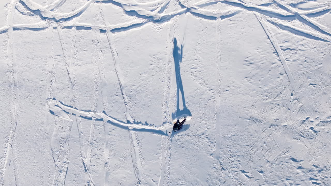Aerial drone view of a sportsman snowkiting on the Giau Pass in the Dolomites, Italy